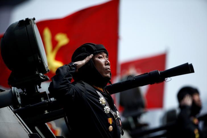 a soldier salutes from atop an armoured vehicle as it drives past the stand with north korean leader kim jong un during a military parade marking the 105th birth anniversary of country 039 s founding father kim il sung in pyongyang april 15 2017 photo reuters