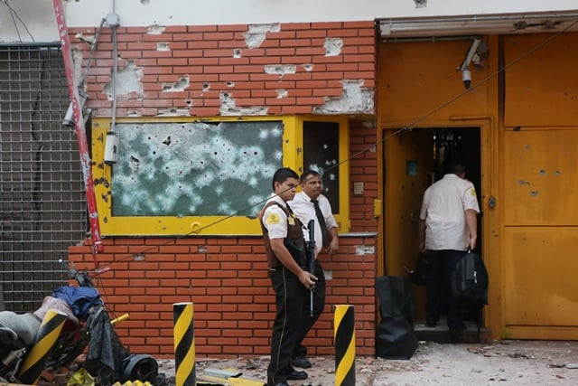 employees remain outside the premises of multinational company prosegur after a robbery in ciudad del este alto parana department paraguay in the triple border with brazil and argentina on april 24 2017 photo afp employees remain outside the premises of multinational company prosegur after a robbery in ciudad del este alto parana department paraguay in the triple border with brazil and argentina on april 24 2017 photo afp