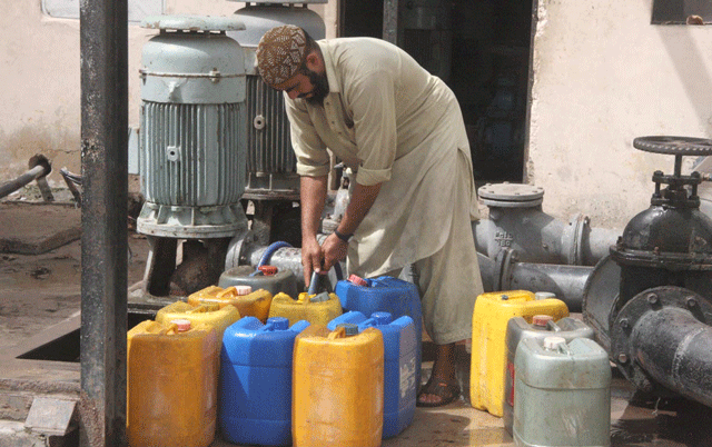 a man fills cans with water at a pumping station in lyari according to irrigation secretary jamal shah 1 200 cusecs of water was required from river indus for the k iv project in karachi photo online