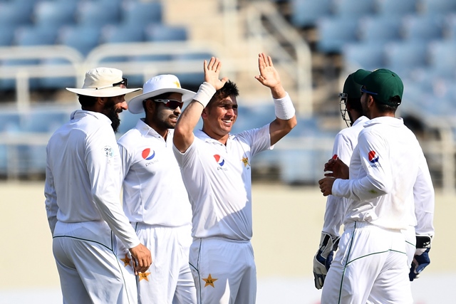 yasir shah celebrates with teammates after bowling out west indies 039 batsman kraigg brathwaite on day four of the first test match between west indies and pakistan at the sabina park in kingston jamaica on april 24 2017 photo afp