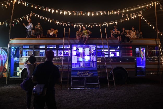 festivalgoers sitting on top of the molam bus at the wonderfruit music festival in chonburi photo afp