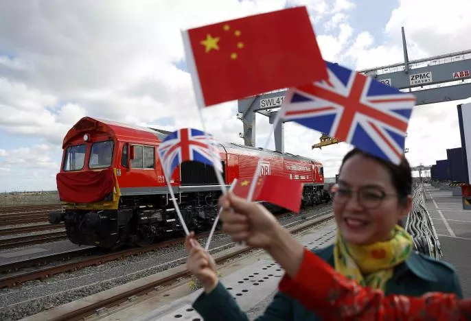 chinese women wave flags at the official ceremony to mark the departure of the first uk to china export train laden with containers of british goods from the dp world london gateway stanford le hope britain photo reuters chinese women wave flags at the official ceremony to mark the departure of the first uk to china export train laden with containers of british goods from the dp world london gateway stanford le hope britain photo reuters