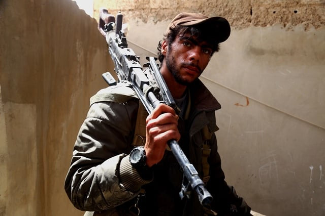 a member of the us backed syrian democratic forces sdf made up of an alliance of arab and kurdish fighters looks on in the town of tabqa about 55 kilometres 35 miles west of raqa city on april 30 2017 photo afp a member of the us backed syrian democratic forces sdf made up of an alliance of arab and kurdish fighters looks on in the town of tabqa about 55 kilometres 35 miles west of raqa city on april 30 2017 photo afp