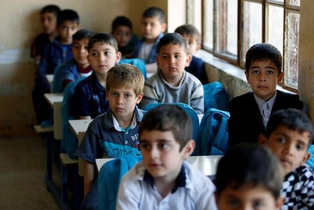 schoolchildren attend their class at school in eastern mosul iraq photo reuters