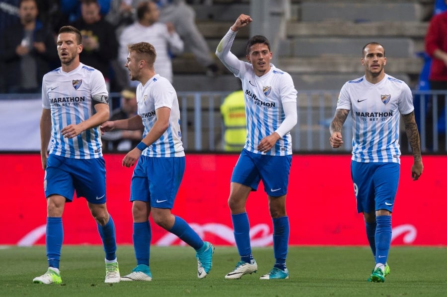 malaga 039 s midfielder pablo fornals 2ndr celebrates past teammates after scoring during the spanish league football match malaga cf vs sevilla fc at la rosaleda stadium in malaga on may 1 2017 photo afp