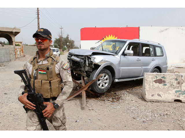 a member of the iraqi kurdish security forces stands guard next to the car of mohammed younis a senior official of iraq 039 s state run north gas company ngc who was killed by gunmen in the northern oil city of kirkuk iraq may 2 2017 photo reuters