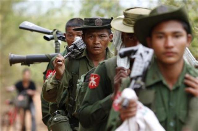 army soldiers carry weapons as they walk to the earthquake struck area in tarlay myanmar photo reuters