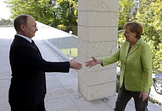 russian president vladimir putin welcomes german chancellor angela merkel during their meeting at the bocharov ruchei state residence in sochi photo afp