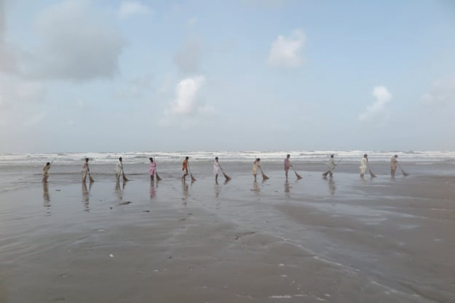 hard at work the artists hired 11 cleaners from cantonment board clifton for a day and asked them to sweep all the sand from the beach into the ocean that the dha forces them to do photo koel gallery hard at work the artists hired 11 cleaners from cantonment board clifton for a day and asked them to sweep all the sand from the beach into the ocean that the dha forces them to do photo koel gallery