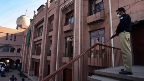 a policeman stands guard inside the compound of an ahmadi worship place photo reuters