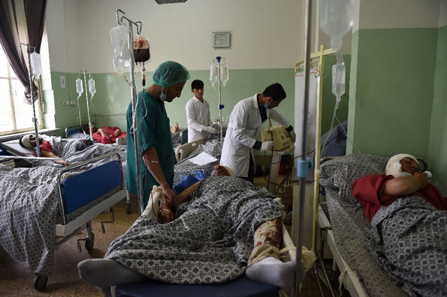 afghan medical personnel treat victims injured in a suicide attack targeting a foreign forces convoy near the us embassy and nato headquarters in kabul afghan medical personnel treat victims injured in a suicide attack targeting a foreign forces convoy near the us embassy and nato headquarters in kabul photo afp