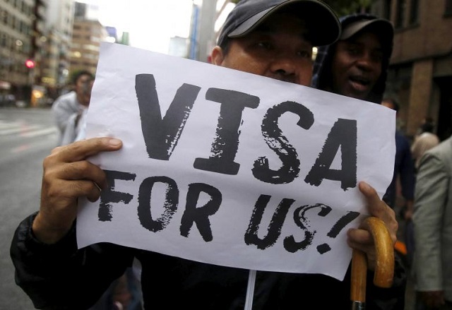 a protester holding a placard shouts slogans at a rally to call for visa grants for asylum seekers in japan in central tokyo photo reuters