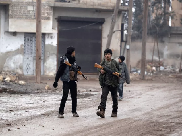 youth carry weapons along a road in al rai town northern aleppo countryside syria photo reuters youth carry weapons along a road in al rai town northern aleppo countryside syria photo reuters