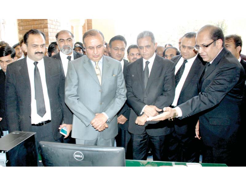 district and sessions judge sohail nasir briefs lhc chief justice mansoor ahmed shah regarding the sms alert service of the court photo express