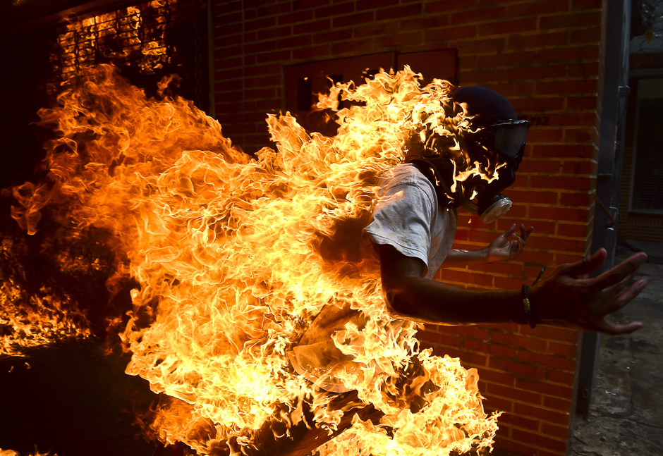 an opposition activist suddenly turned into a human torch runs upon clashing with riot police during a protest against venezuelan president nicolas maduro in caracas photo afp