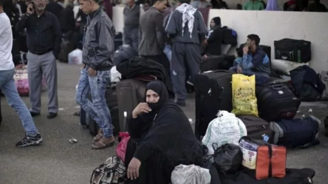 a palestinian woman sits next to her luggage as she waits to cross to the egyptian side of the rafah border crossing in rafah gaza strip photo ap a palestinian woman sits next to her luggage as she waits to cross to the egyptian side of the rafah border crossing in rafah gaza strip photo ap