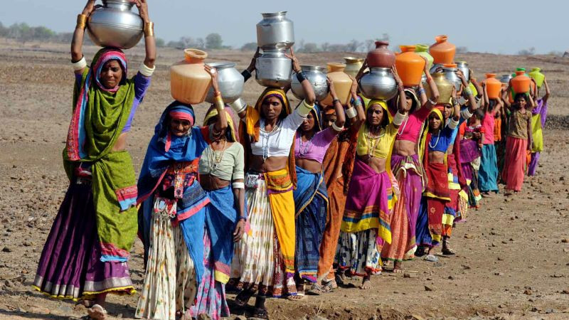 women carrying water in arid area