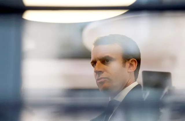 emmanuel macron head of the political movement en marche or onwards and candidate for the 2017 presidential election is pictured through a window of his hotel during a campaign visit in rodez france may 5 2017 photo afp emmanuel macron head of the political movement en marche or onwards and candidate for the 2017 presidential election is pictured through a window of his hotel during a campaign visit in rodez france may 5 2017 photo afp