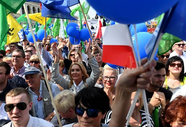 demonstrators hold polish and eu flags during the freedom march in the polish capital warsaw on may 6 2017 photo afp demonstrators hold polish and eu flags during the freedom march in the polish capital warsaw on may 6 2017 photo afp