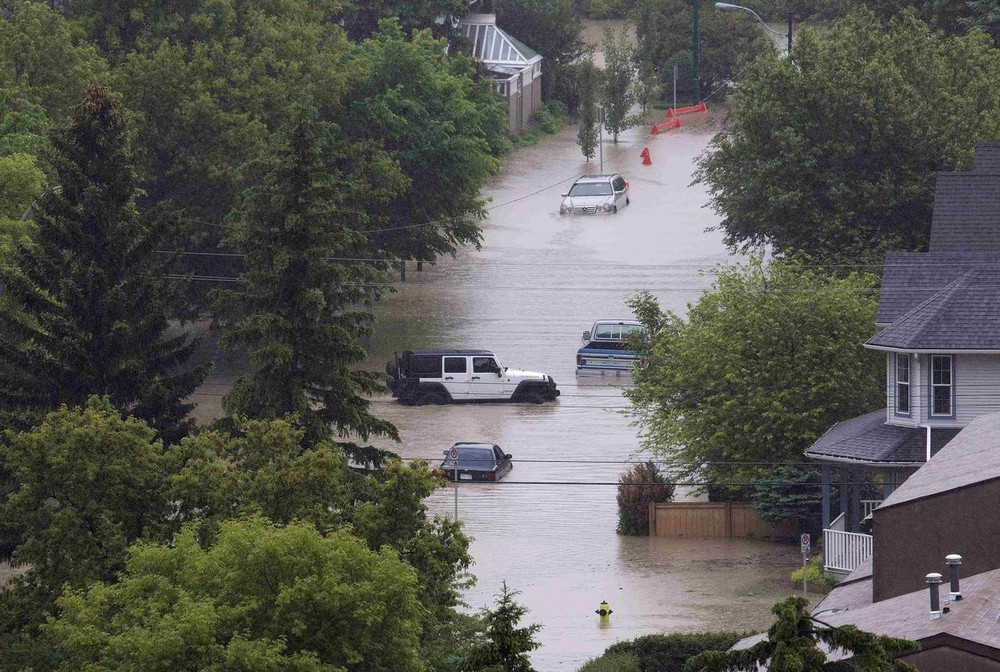 vehicles surrounded by floodwaters are seen in the neighbourhood of sunnyside in calgary alberta photo reuters