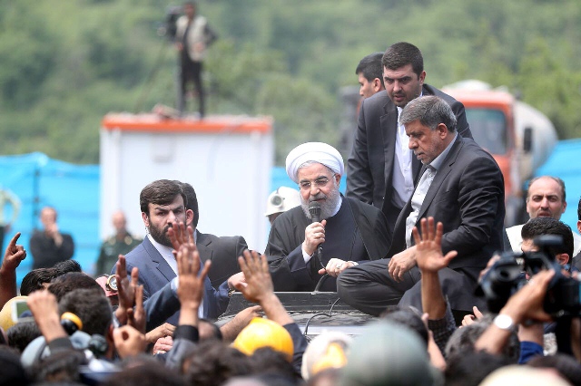 a handout picture provided by the office of iranian president hassan rouhani on may 7 2017 shows him c sitting through the roof of a car visiting and speaking with coal miners and rescue workers at the scene of a coal mine which suffered from an explosion photo afp