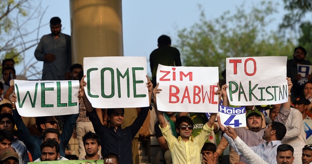pakistani spectators carry placards as they await the start of the first international t20 cricket match between pakistan and zimbabwe at the gaddafi cricket stadium in lahore on may 22 2015 photo afp