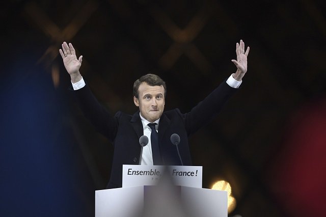 french president elect emmanuel macron greets supporters as he arrives to deliver a speech in front of the pyramid at the louvre museum in paris on may 7 2017 after the second round of the french presidential election photo afp