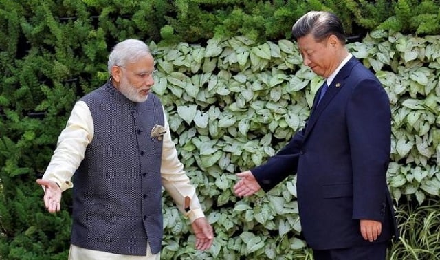 indian prime minister narendra modi l and chinese president xi jinping leave after a group picture during brics brazil russia india china and south africa summit in benaulim in the western state of goa india photo reuters