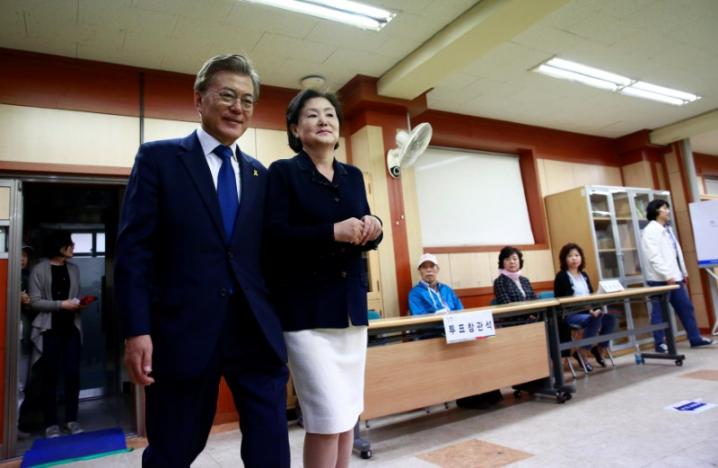 moon jae in l the presidential candidate of the liberal democratic party of korea and his wife kim jung suk r arrive to cast their ballot at a junior high school in seoul south korea 09 may 2017 as voting began across south korea for a presidential election photo reuters