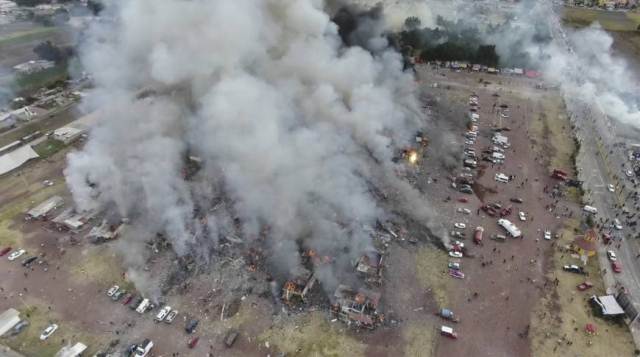 this image made drone video footage shows smoke billowing from the san pablito market where an explosion ripped through a fireworks market in tultepec mexico on 21st december 2016 photo afp