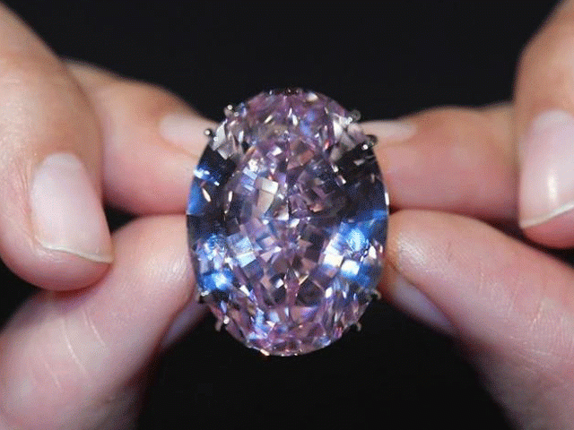 a model poses with a 59 60 carat mixed cut diamond known as 039 039 the pink star 039 039 the largest internally flawless fancy vivid pink diamond ever graded by the geological institute of america gia ahead of being auctioned in hong kong next month by sotheby 039 s which said it could photo reuters