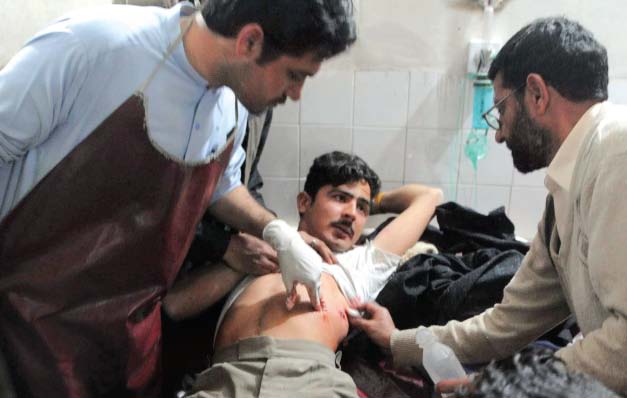paramedics tend to a wounded victim of the suicide attack at a hospital in peshawar photo afp