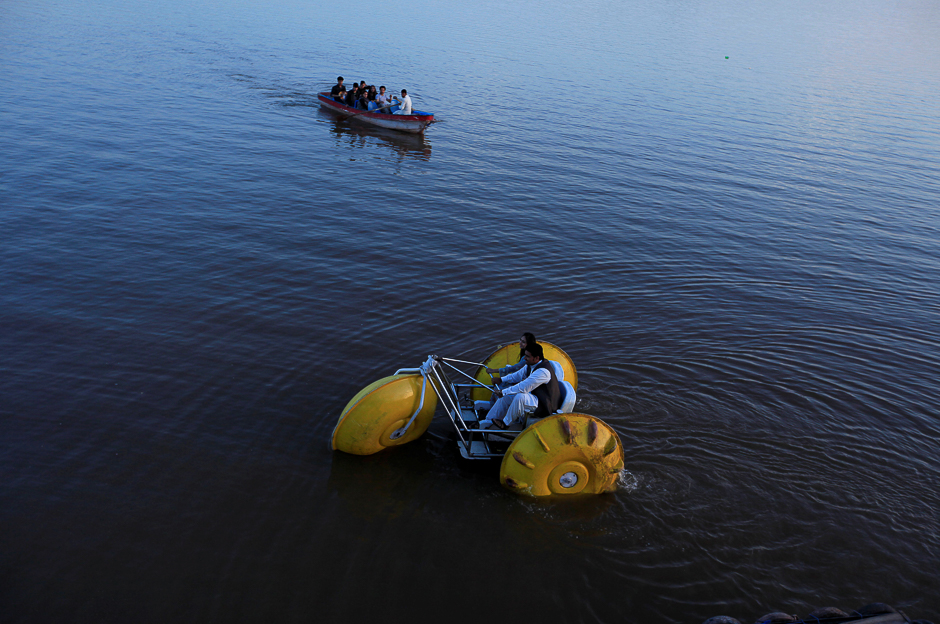 a couple rides a paddleboat down the rawal lake in islamabad while it has lot of plastic pollution photo reuters