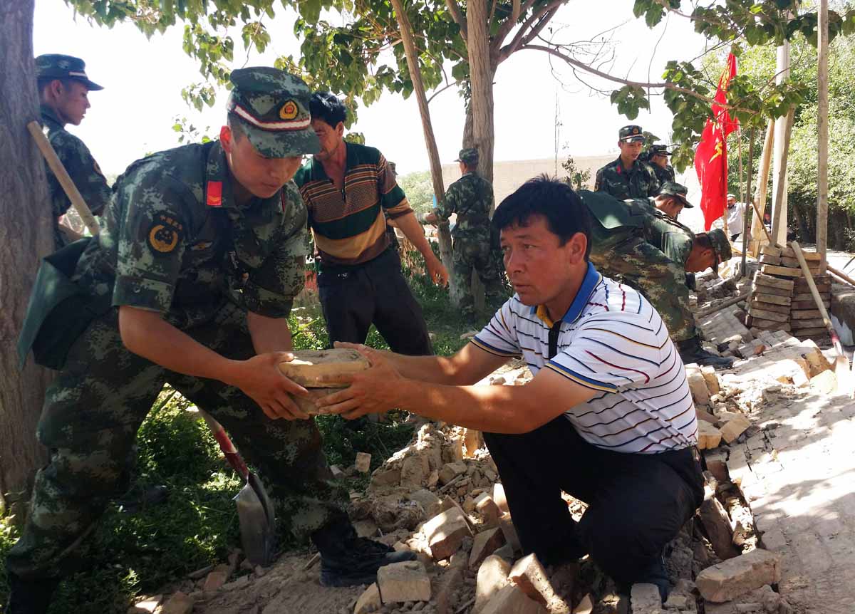 villagers and members of the chinese army clear rubble after an earthquake in pishan county in hetian in china 039 s northeast xinjiang region photo afp