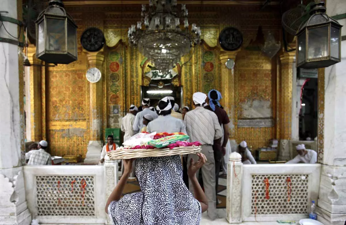 a girl carries a basket of offerings on her head to the shrine of sufi saint khwaja moinuddin chishti photo reuters a girl carries a basket of offerings on her head to the shrine of sufi saint khwaja moinuddin chishti photo reuters