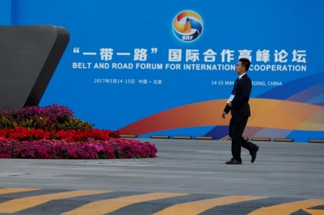a man walks past the china national convention center a venue of the upcoming belt and road forum in beijing china may 12 2017 photo reuters