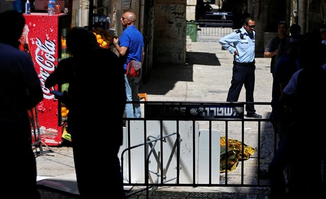 an israeli policeman stands next to a covered dead body following an incident in the old city of jerusalem may 13 2017 photo reuters an israeli policeman stands next to a covered dead body following an incident in the old city of jerusalem may 13 2017 photo reuters