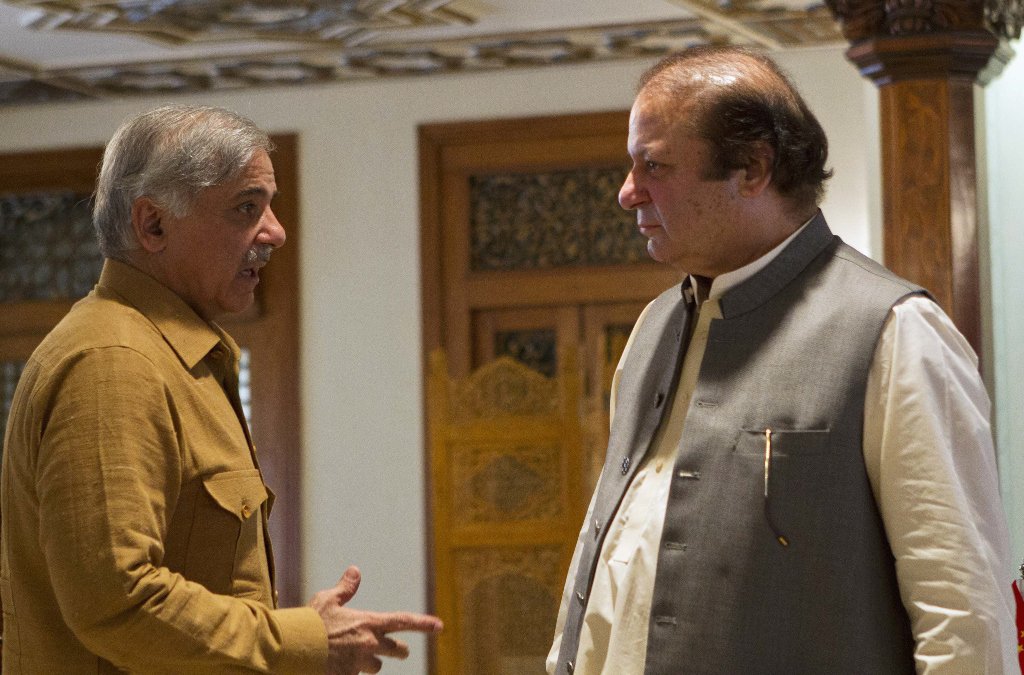 prime minister nawaz shairf in a conversation with brother and punjab chief minister shehbaz sharif photo reuters