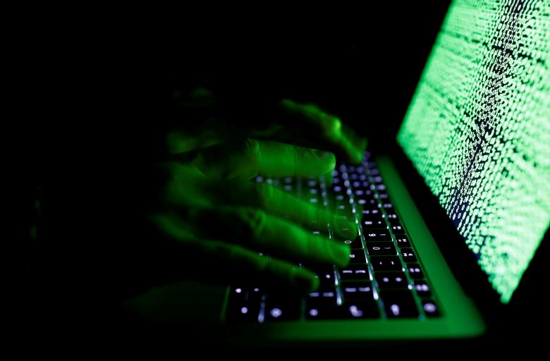 a man types on a computer keyboard in front of the displayed cyber code in this illustration picture photo reuters