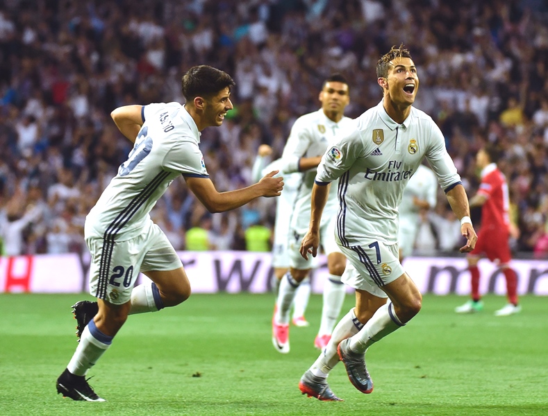 real madrid 039 s portuguese forward cristiano ronaldo celebrates with real madrid 039 s midfielder marco asensio after scoring during the spanish league football match real madrid cf vs sevilla fc at the santiago bernabeu stadium in madrid on may 14 2017 photo afp