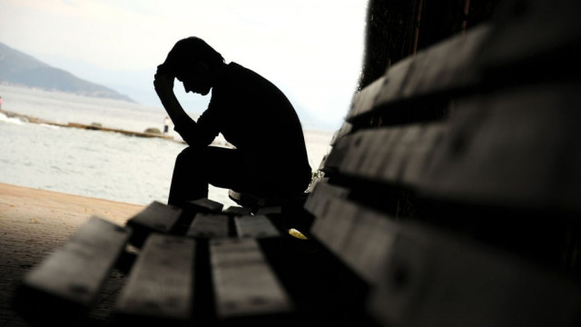 young man sitting looking upset young man sitting looking upset