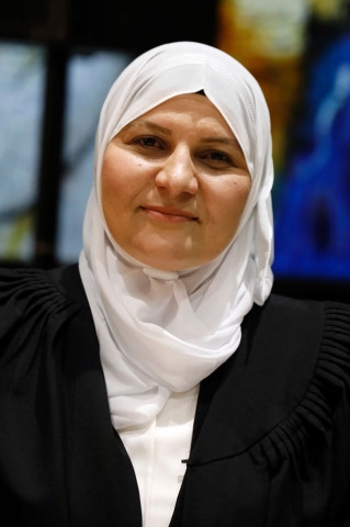 israeli muslim hana khatib the first woman in israel to be appointed by an israeli justice committee to become a religious judge or qadi in the courts ruling on personal law for muslims poses for a photo on may 15 2017 during her swearing in ceremony at the president s residence in jerusalem photo afp