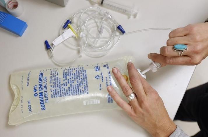 a nurse prepares a bag of saline photo reuters