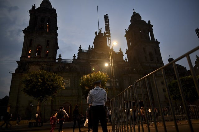 a police officer stands guard in front of the main cathedral on el zocalo square in mexico city on may 15 2017 after a knife wielding assailant stabbed a priest while delivering mass tried to flee but was caught in the church officials said photo afp a police officer stands guard in front of the main cathedral on el zocalo square in mexico city on may 15 2017 after a knife wielding assailant stabbed a priest while delivering mass tried to flee but was caught in the church officials said photo afp