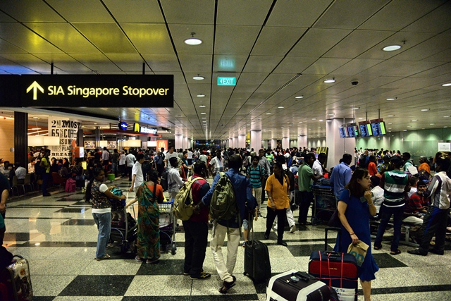 passengers gather at changi international airport terminal 3 after being evacuated from terminal 2 due to a fire in singapore on may 16 2017 photo afp