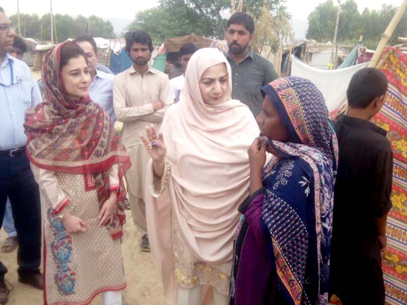 minister of state for national health services saira afzal tarar talks to a local while visiting an ongoing vaccination campaign in the capital photo inp