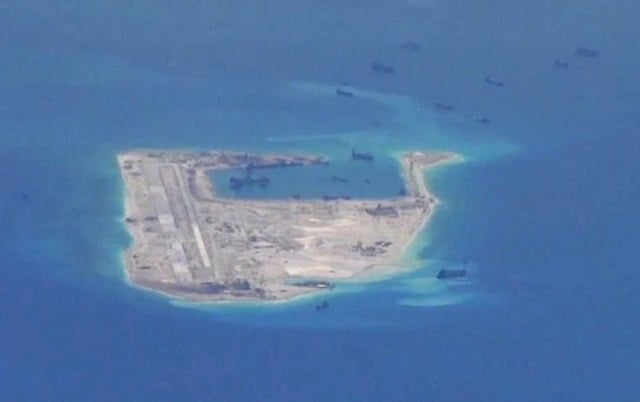 chinese dredging vessels are purportedly seen in the waters around fiery cross reef in the disputed spratly islands in the south china sea in this still image from video taken by a p 8a poseidon surveillance aircraft provided by the united states navy photo reuters