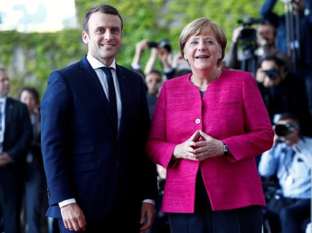 german chancellor angela merkel and french president emmanuel macron arrive at a ceremony at the chancellery in berlin germany may 15 2017 photo reuters