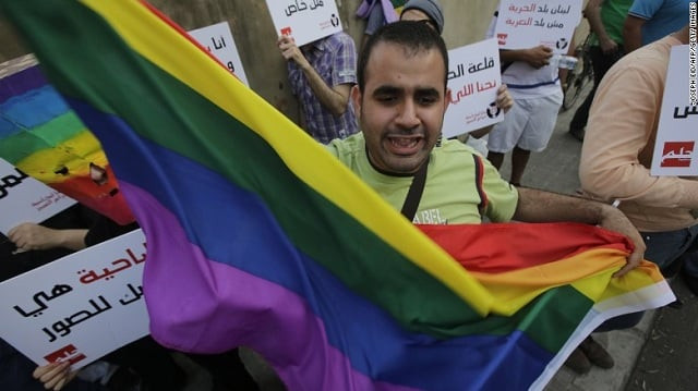 a protester waves the gay pride flag as others hold banners during an anti homophobia rally in beirut on april 30 2013 photo courtesy cnn a protester waves the gay pride flag as others hold banners during an anti homophobia rally in beirut on april 30 2013 photo courtesy cnn