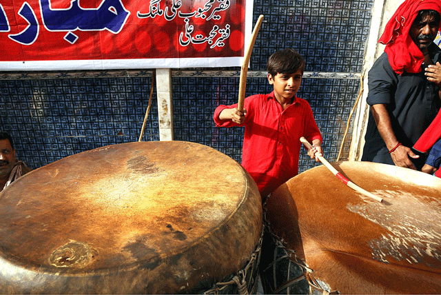 a young devotee plays the naqqara during urs celebrations at hazrat lal shahbaz qalandar 039 s shrine photo app